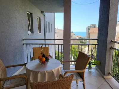 a table with a bowl of fruit on a balcony at Apartment Rachel in Petrovac na Moru