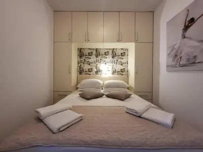 a bedroom with a large bed with two pillows at Apartment Rachel in Petrovac na Moru