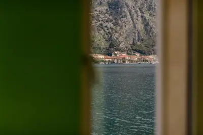 a view of a body of water through a window at Sea Holiday Muo with Sea and City View in Kotor