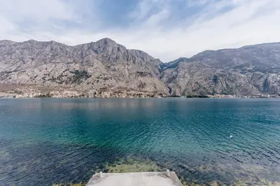 a view of a large body of water with mountains at Sea Holiday Muo with Sea and City View in Kotor