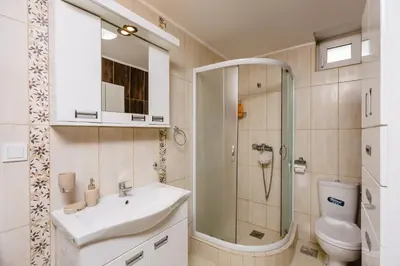 a bathroom with a sink and a shower and a toilet at Sea Holiday Muo with Sea and City View in Kotor