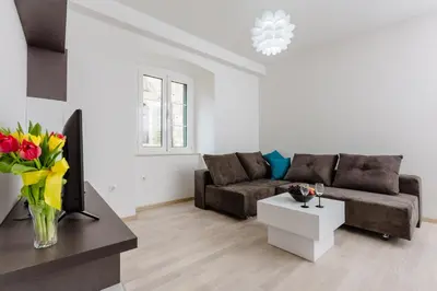 a living room with a couch and a table at Old Town Summer Apartment in Kotor