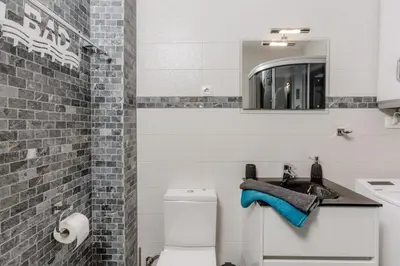 a bathroom with a white toilet and a sink at Old Town Summer Apartment in Kotor