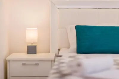 a bedroom with a bed and a lamp on a nightstand at Old Town Summer Apartment in Kotor