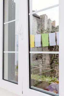 a window with towels hanging on a clothesline at Old Town Summer Apartment in Kotor