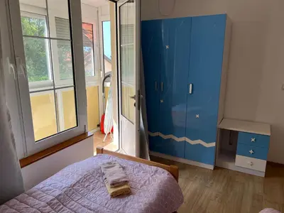 a bedroom with a bed and a blue cabinet at Zubci mountain apartment in Bar
