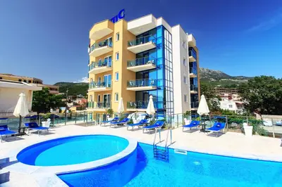 a hotel with a swimming pool in front of a building at Atlantic Hotel in Dobra Voda
