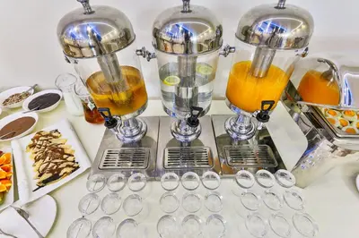 a counter with two cups of orange juice at Atlantic Hotel in Dobra Voda