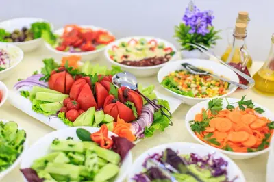 a table with many plates of vegetables on it at Atlantic Hotel in Dobra Voda