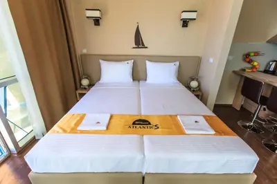 a hotel room with a bed with two pillows at Atlantic Hotel in Dobra Voda