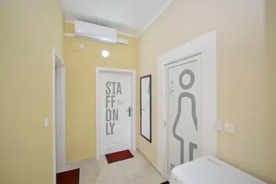a hallway with a door with a sign on it at Hostel Pupa in Kotor
