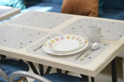 a table with a plate and a cup on it at Hostel Pupa in Kotor
