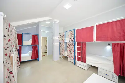 a room with two bunk beds with red curtains at Hostel Pupa in Kotor