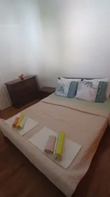 a bed with three towels on top of it at Apartman Ozi in Petrovac na Moru