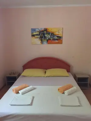 a bedroom with a bed with two towels on it at Holiday Home Aksentijevic in Sutomore