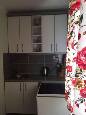 a kitchen with white cabinets and a sink at Holiday Home Aksentijevic in Sutomore