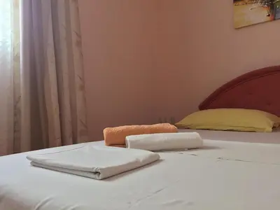 a bed with two towels sitting on top of it at Holiday Home Aksentijevic in Sutomore