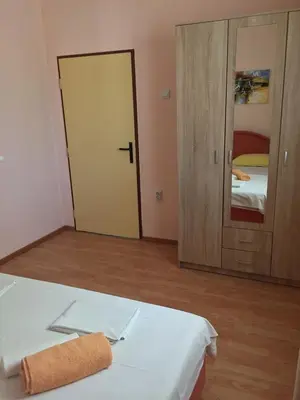 a room with a bed with a towel on it at Holiday Home Aksentijevic in Sutomore