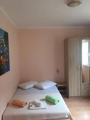 a bedroom with a bed with two towels on it at Holiday Home Aksentijevic in Sutomore