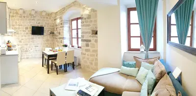 a living room with a couch and a table at La Dolce Vita Apartment in Kotor