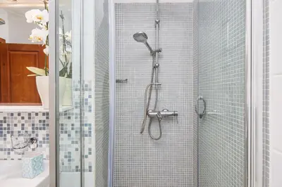 a bathroom with a shower with a glass door at La Dolce Vita Apartment in Kotor