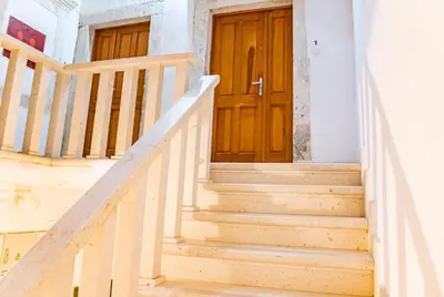 a set of stairs with a wooden door at La Dolce Vita Apartment in Kotor