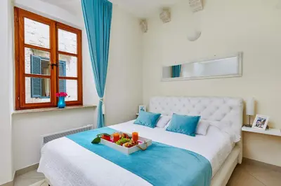 a bedroom with a bed with a bowl of fruit on it at La Dolce Vita Apartment in Kotor