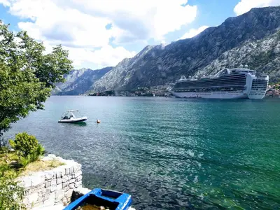 a cruise ship and a boat in a body of water at La Dolce Vita Apartment in Kotor