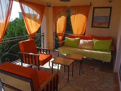 a living room with a couch and chairs on a balcony at Star Home in Kotor