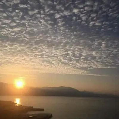 a sunset over a body of water with the sun at Star Home in Kotor