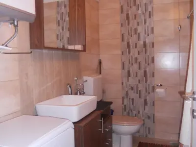 a small bathroom with a sink and a toilet at Apartment Mika in Budva