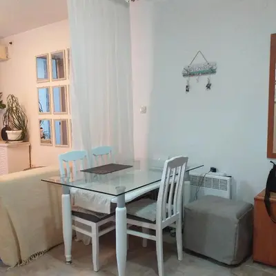 a dining room with a glass table and chairs at Apartment Mika in Budva