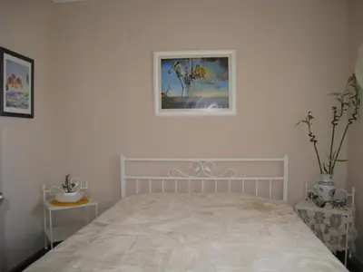 a bedroom with a bed and a picture on the wall at Apartment Mika in Budva
