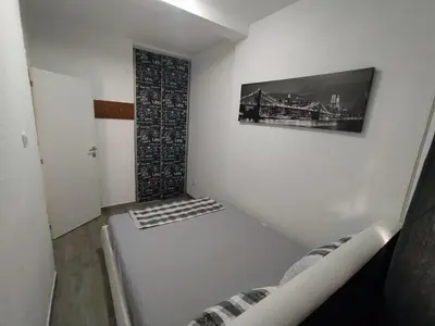 a room with a staircase with a picture on the wall at Apartment Maska in Budva