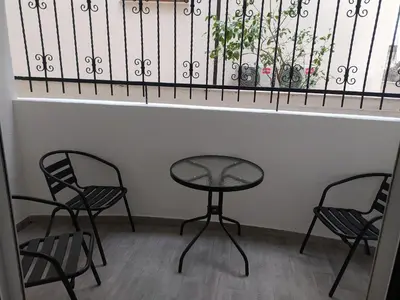 two chairs and a table in front of a window at Apartment Maska in Budva