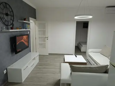 a living room with a couch and a tv at Apartment Maska in Budva