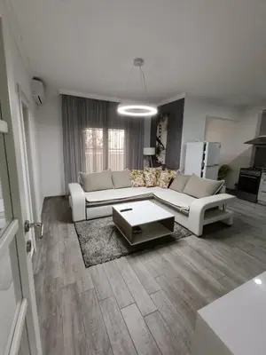 a living room with a couch and a table at Apartment Maska in Budva