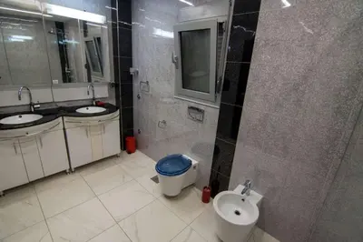a bathroom with two sinks and a toilet and a mirror at Lux Villa Ivan Budva in Budva