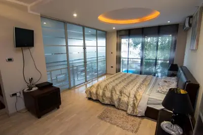 a bedroom with a bed and a large window at Lux Villa Ivan Budva in Budva