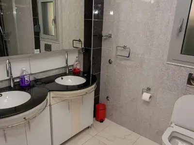 a bathroom with two sinks and a shower at Lux Villa Ivan Budva in Budva