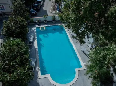 an overhead view of a blue swimming pool with trees at Lux Villa Ivan Budva in Budva