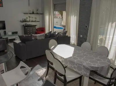 a living room with a table and a couch at Lux Villa Ivan Budva in Budva