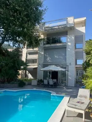 a large blue swimming pool in front of a building at Lux Villa Ivan Budva in Budva