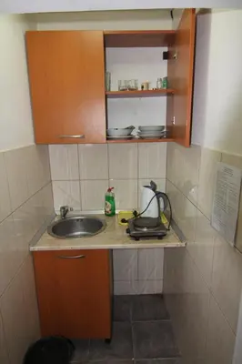 a small kitchen with a sink and a counter at Apartments in villa Viktoria in Sutomore