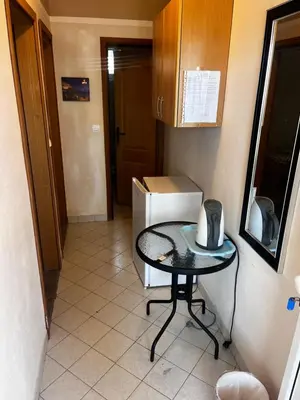a small kitchen with a table and a microwave at Apartments in villa Viktoria in Sutomore