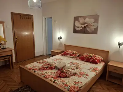 a bedroom with a large bed with red pillows at Apartments Ardoni in Ulcinj