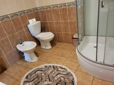 a bathroom with a toilet and a shower and a sink at Apartments Ardoni in Ulcinj