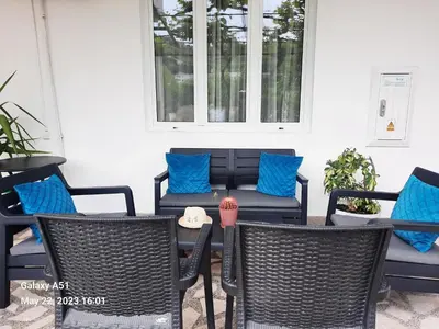 a patio with chairs and a table with blue pillows at Apartments Ardoni in Ulcinj