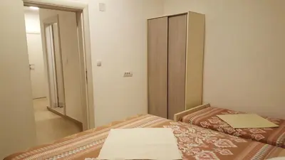 a bedroom with two beds and a mirror at Apartments Ardoni in Ulcinj