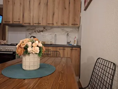 a vase with flowers on a table in a kitchen at Apartments Ardoni in Ulcinj